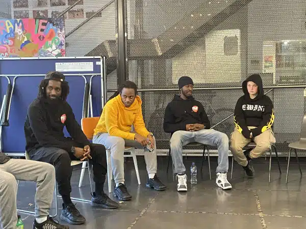 An interview with the Weapon Of Choice Team 6 group of young men in a meeting