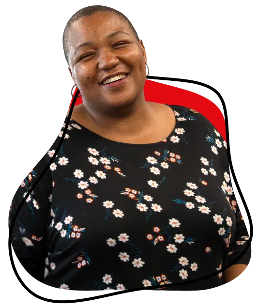 A smiling person with short hair wears a black shirt with a white floral pattern. There is a red accent and a black outlined shape behind them, against a light grey background.