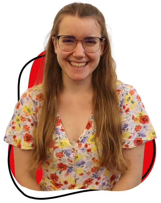 A young woman with long brown hair and glasses smiles at the camera. She is wearing a floral dress with red, yellow, and blue flowers. The background is white with a red and black abstract shape behind her.