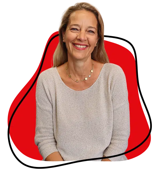 Smiling woman with long blonde hair wearing a light knitted jumper and a gold necklace, sitting in front of a white background with a red abstract shape outlined in black behind her.